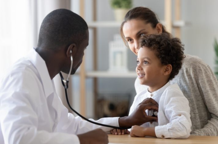 A Rockwell primary-care provider examining a young child during a checkup