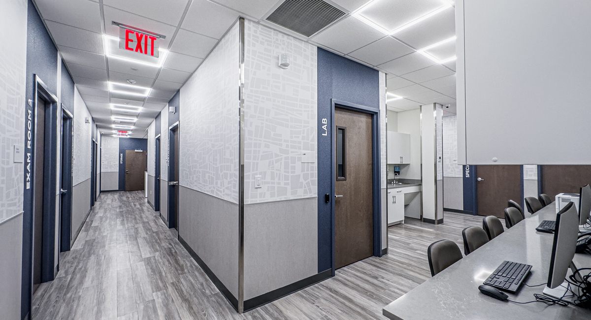 A bright Rockwell clinic corridor lined with exam rooms in Brooklyn